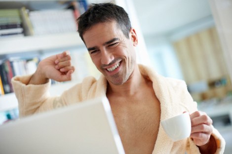 Man Wearing Bathrobe Using Laptop Computer
